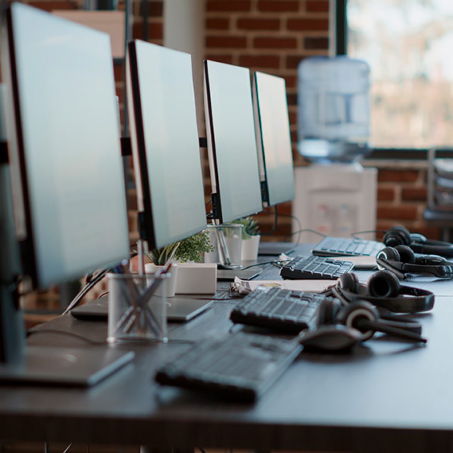 nobody-in-empty-call-center-workstation-with-compu-2023-11-27-04-50-03-utc